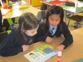 P5 and P3 pair read as part of Literacy week.