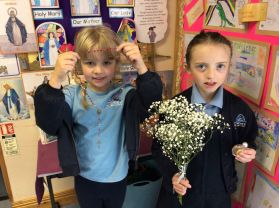 Lilly and Erin help decorate our May altar